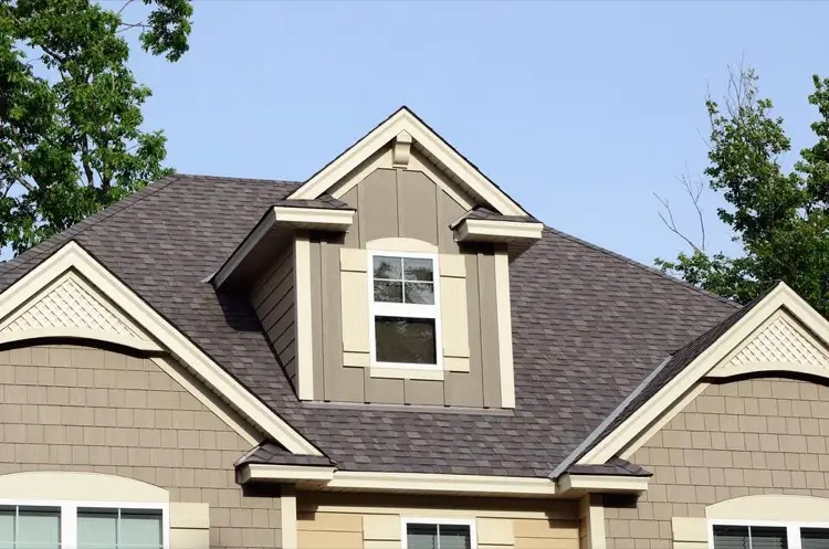 Beige house with dark gray architectural shingle roof