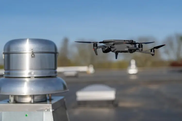 Drone performing aerial inspection of a commercial flat roof