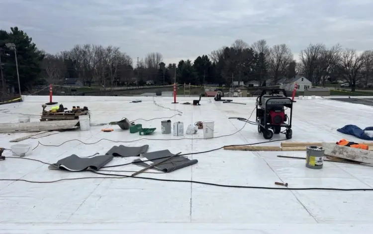 Better Way Roofing crew installing a white TPO membrane on a commercial flat roof in Northern Indiana