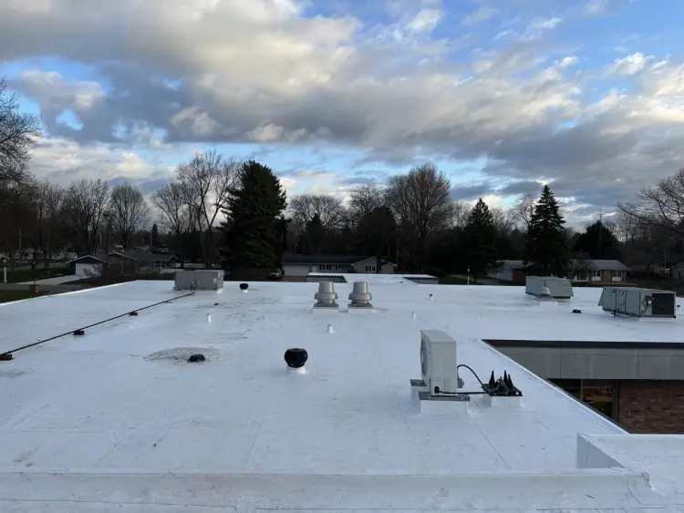 Completed white commercial membrane roof with rooftop HVAC units on a building in Northern Indiana