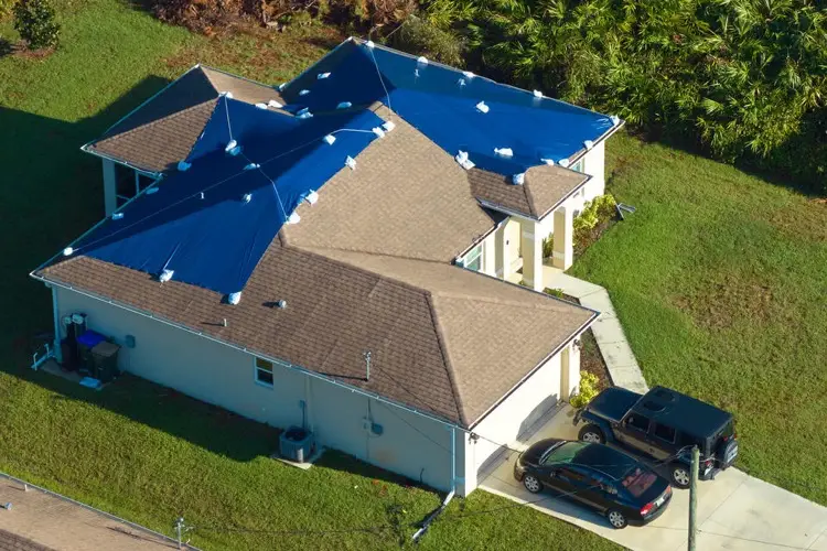 Aerial view of emergency tarp covering damaged roof