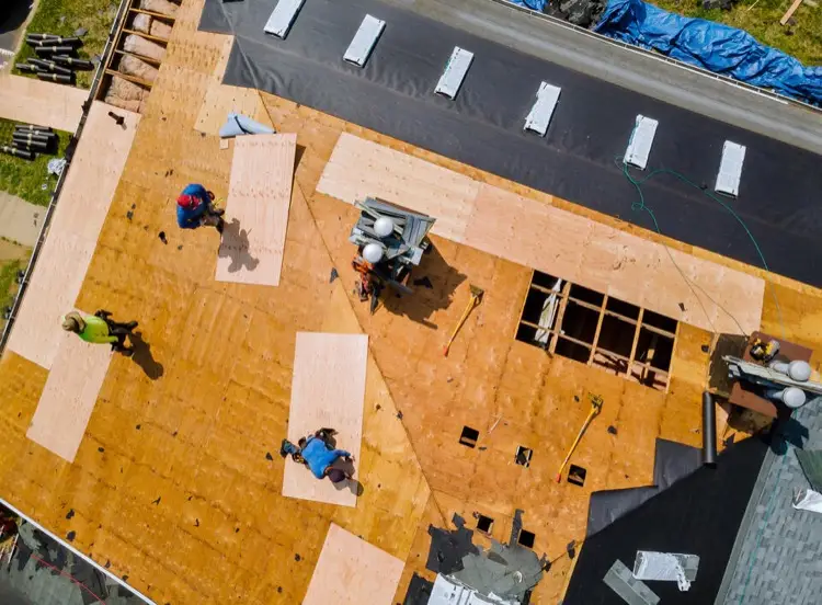 Aerial view of exposed roof decking and underlayment