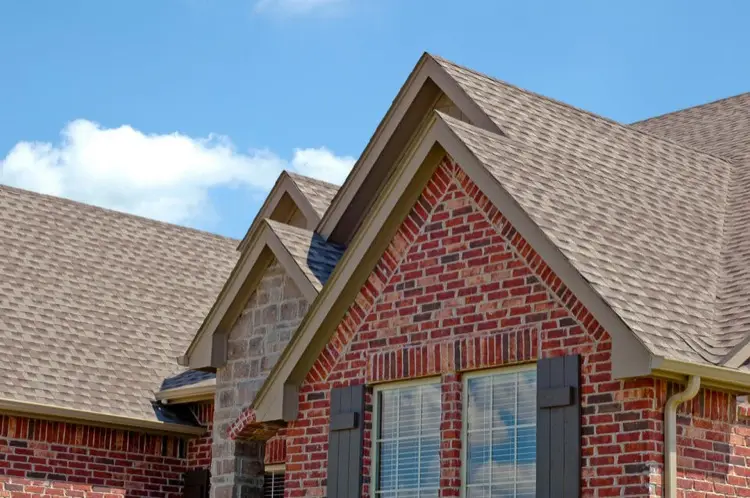 Red brick house with gray shingle roof