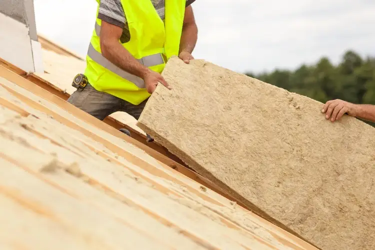 Roof insulation being installed by roofers