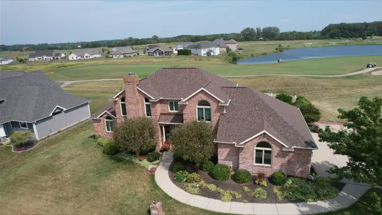 Roofing contractor reviewing project documents with homeowner