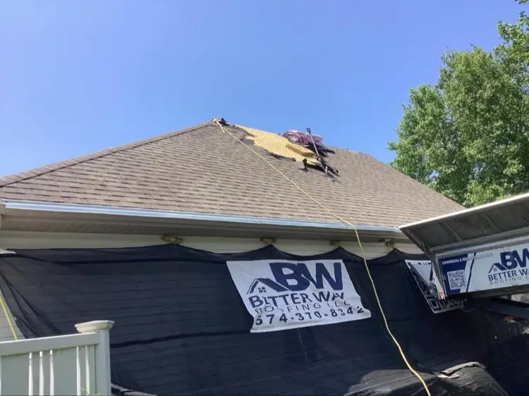 Job site with safety equipment and roofing debris cleanup