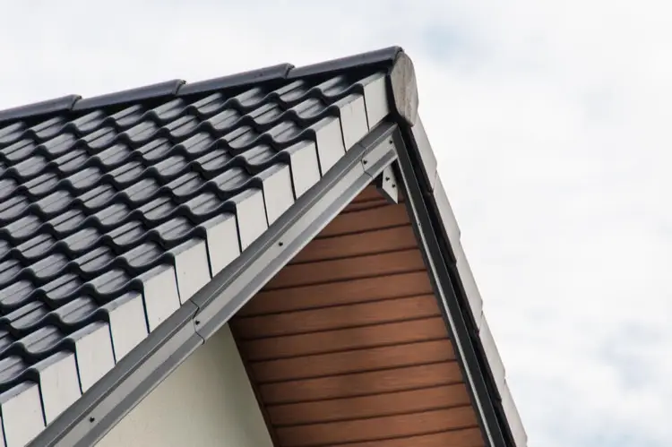 Close up of black metal shingle roof with overhang