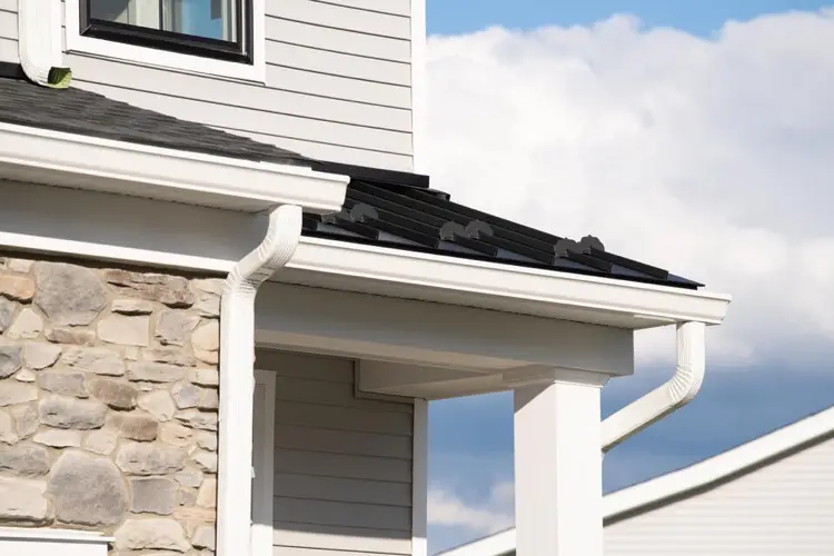 Porch overhang on a white sided house