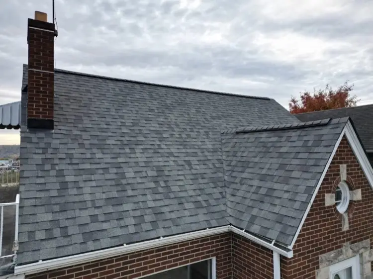 Brick residential home with new asphalt shingle roof