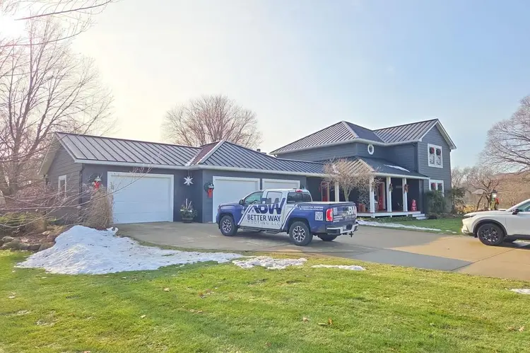Black textured standing seam metal roof on a two-story navy home in Granger Indiana, installed by Better Way Roofing