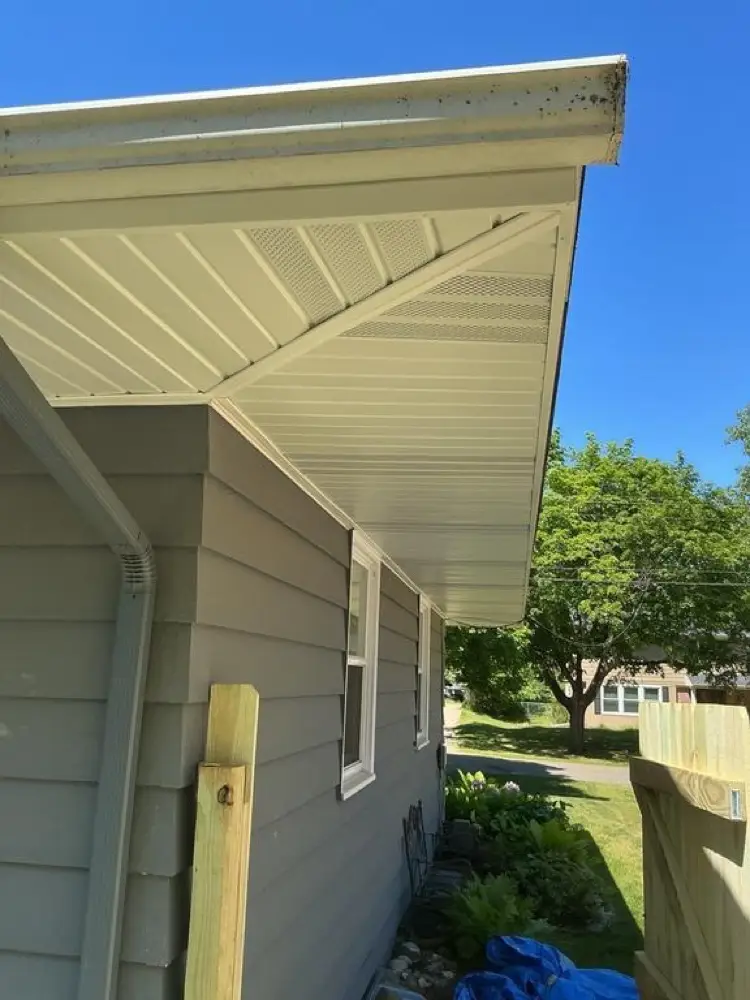 Side view of a roof edge showing how the fascia board, gutter, and soffit meet