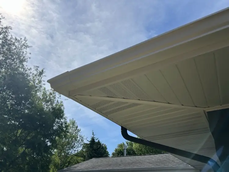 Looking up at vented soffit panels with the fascia wrapping the corner of the roof