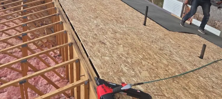 New OSB roof sheeting being installed over rafters
