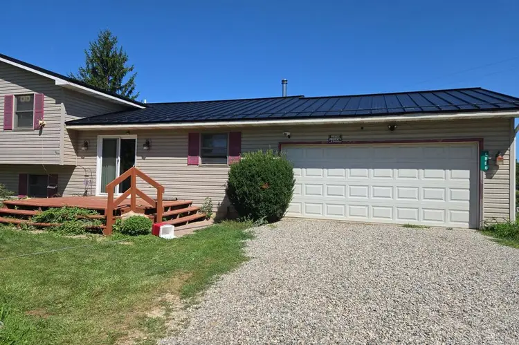 Black textured standing seam metal roof on a split-level home in Camden Michigan, installed by Better Way Roofing
