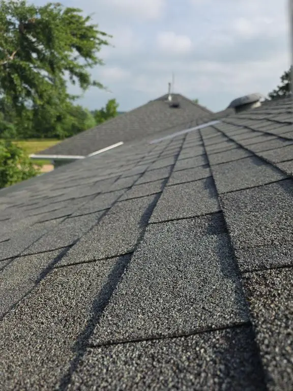 Worn shingles with heavy granule loss on a Shipshewana roof before sectional repair