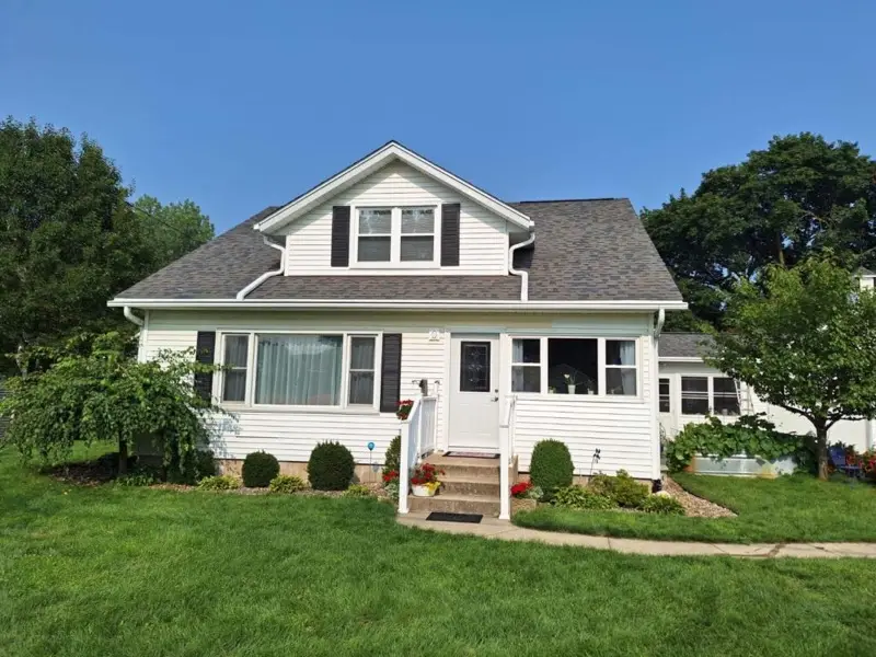 White farmhouse in Shipshewana, LaGrange County, Indiana with an asphalt shingle roof maintained by Better Way Roofing.