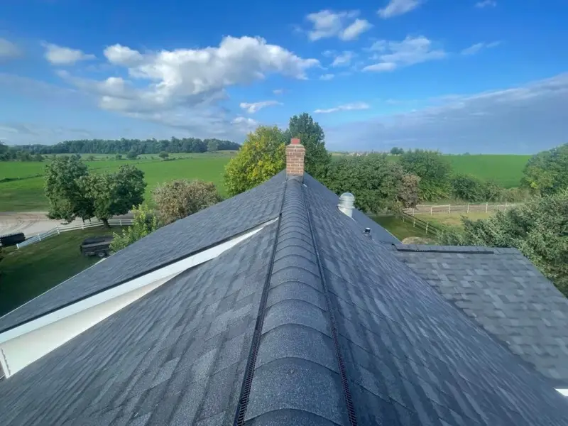 Ridge detail of a completed asphalt shingle roof replacement in Granger, Indiana, showing new ridge vent and architectural shingles.