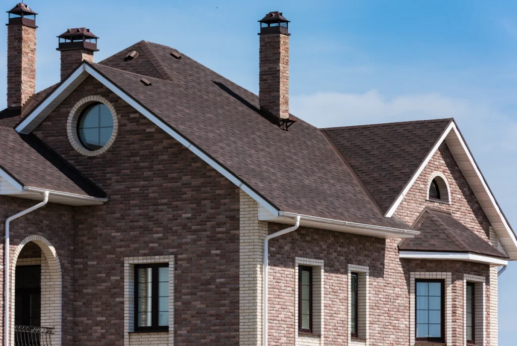 roofing brown shingles brick home