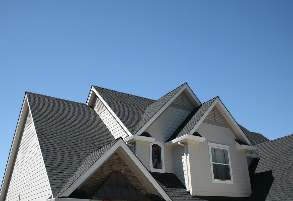 best roof shingles-steep pitched roof with new dark gray roof shingles