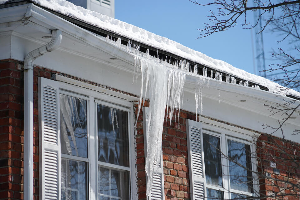 how to prevent ice dams on roof-brick house with ice and snow ruining gutter system on roof