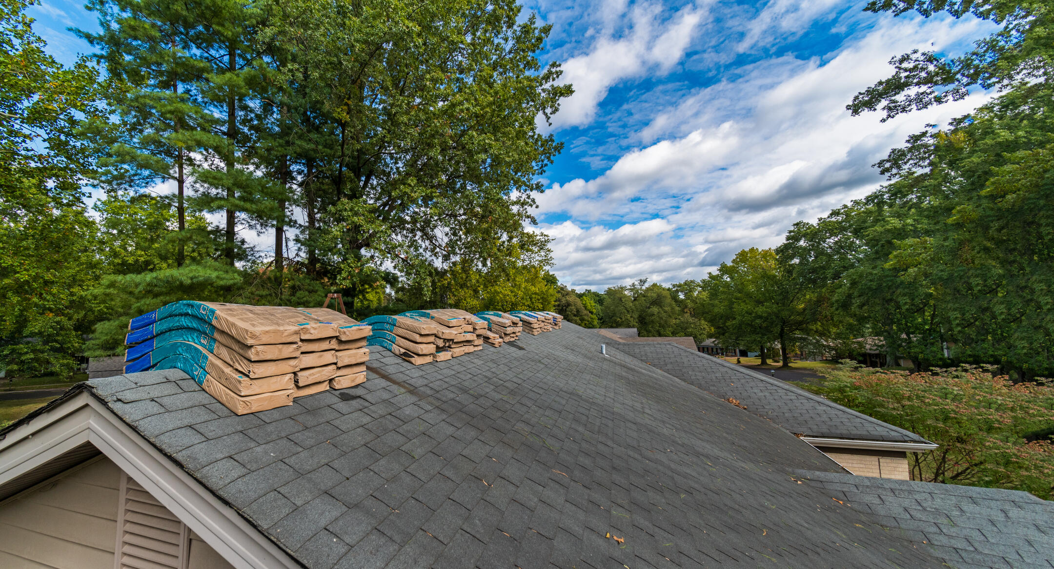 how long does it take to replace a roof-view of current shingle roof being prepared for roof replacement