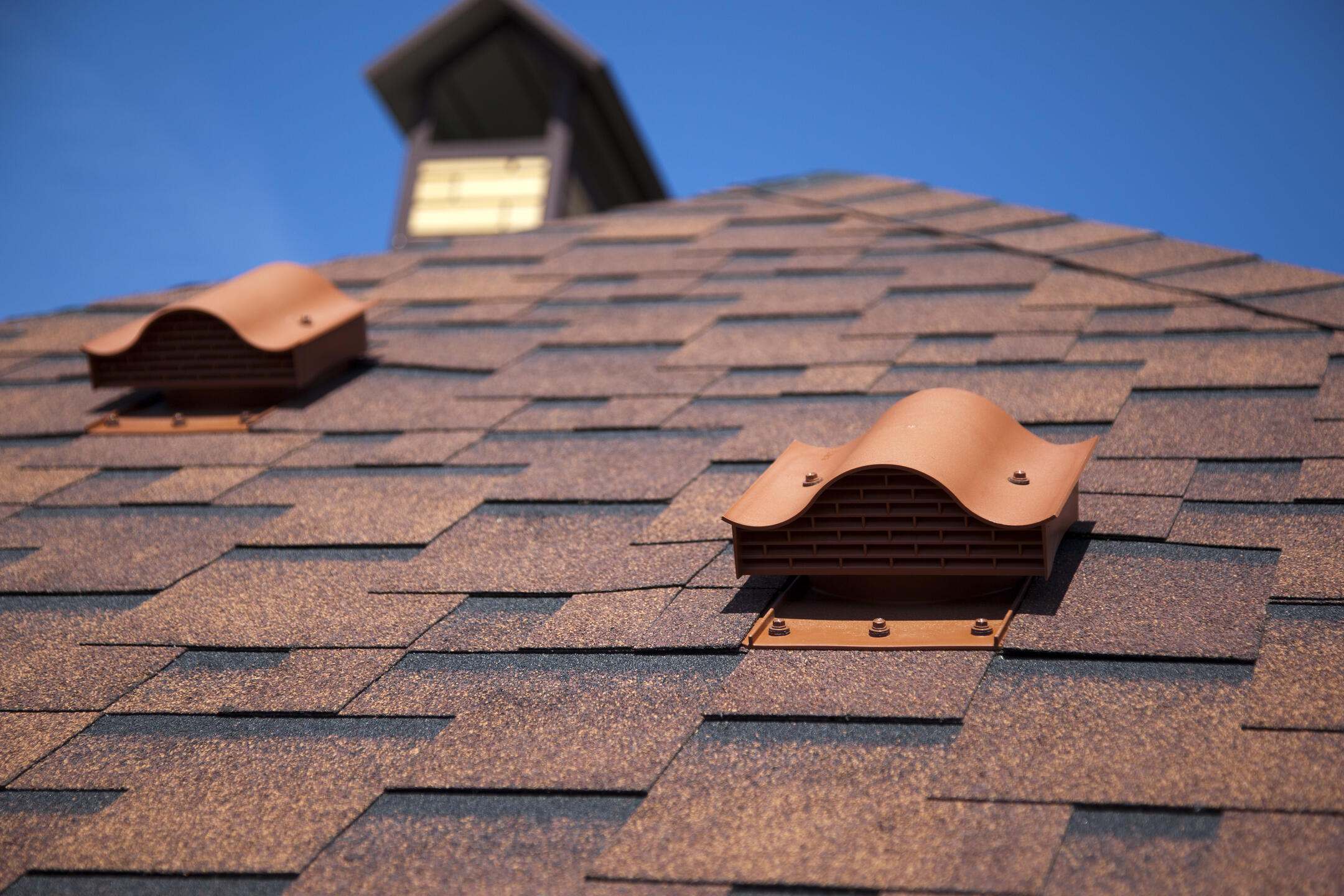 parts of a roof-roof ventilation on brown shingled roof