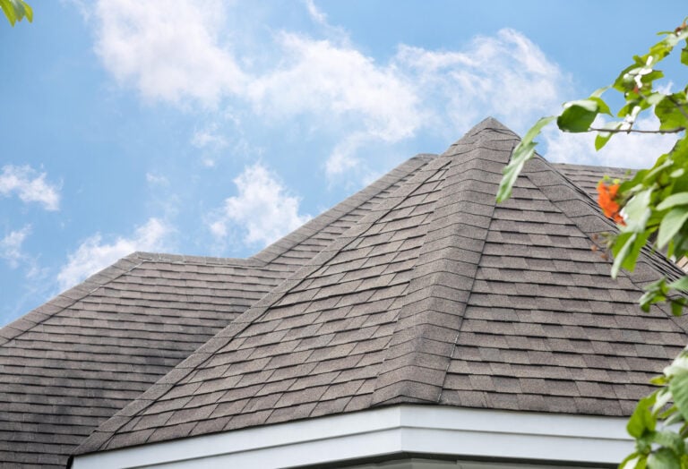 best-roof-shinglesgray-roof-shingles-on-a-house-with-a-blue-sky-background
