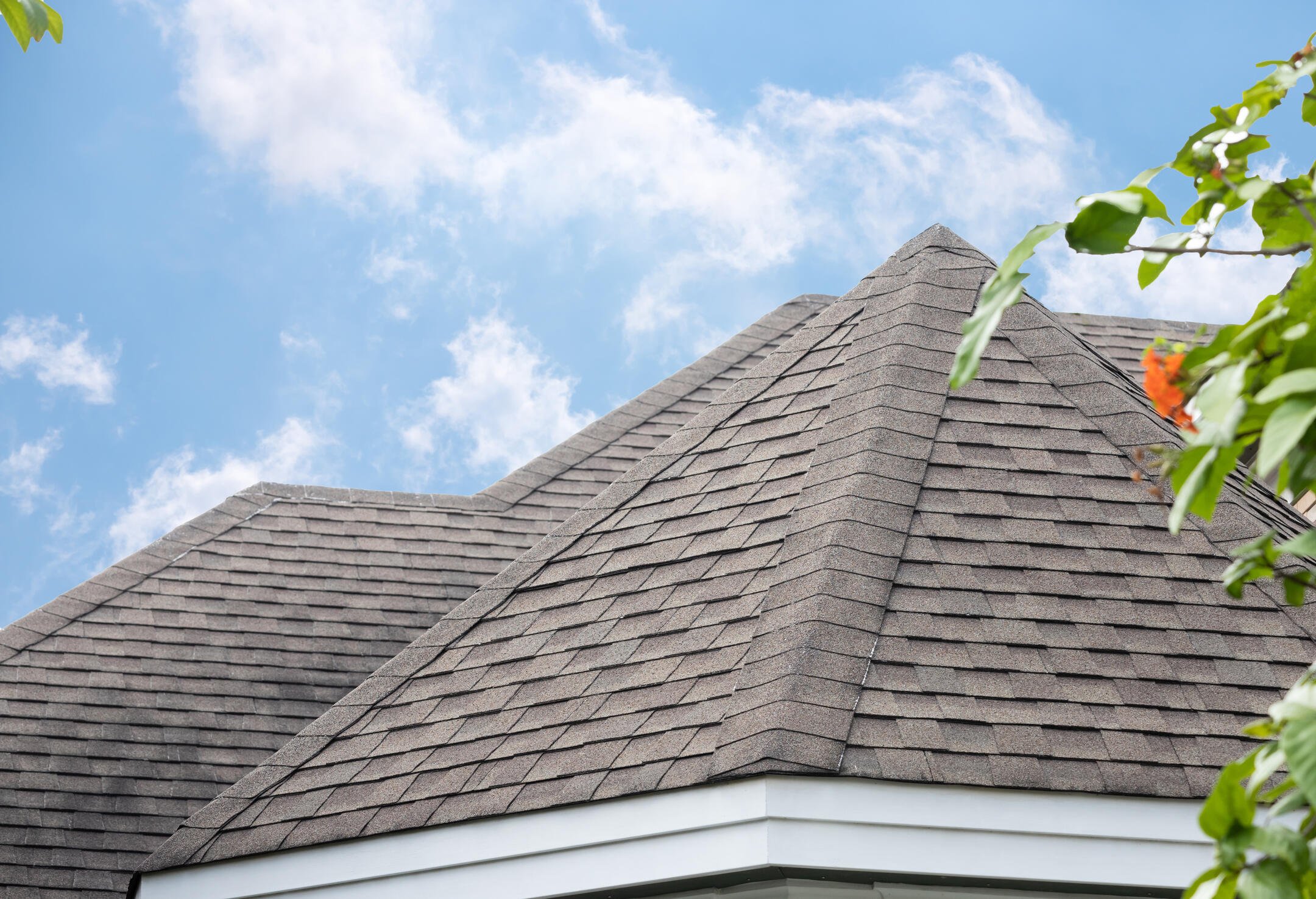 best-roof-shinglesgray-roof-shingles-on-a-house-with-a-blue-sky-background